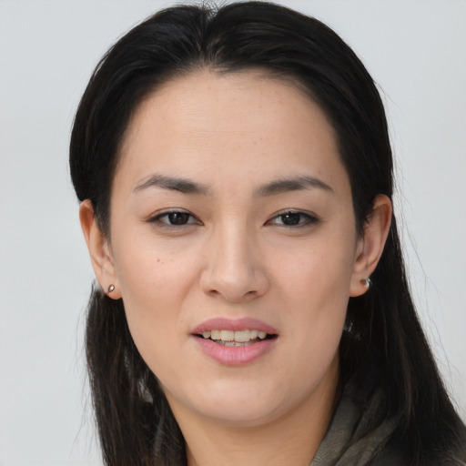 Joyful asian young-adult female with long  brown hair and brown eyes