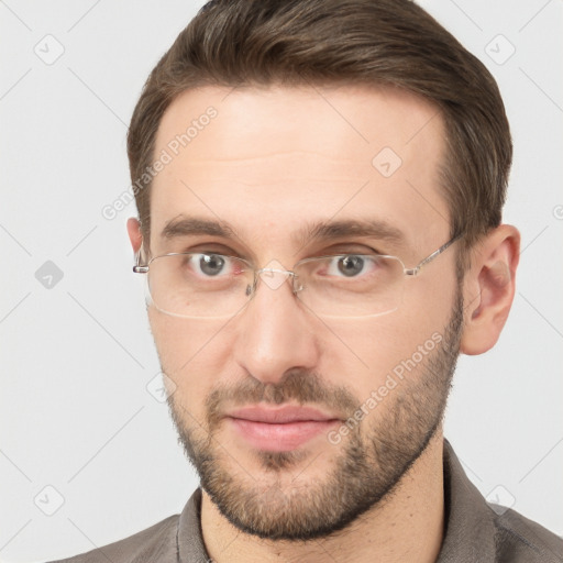 Joyful white young-adult male with short  brown hair and grey eyes