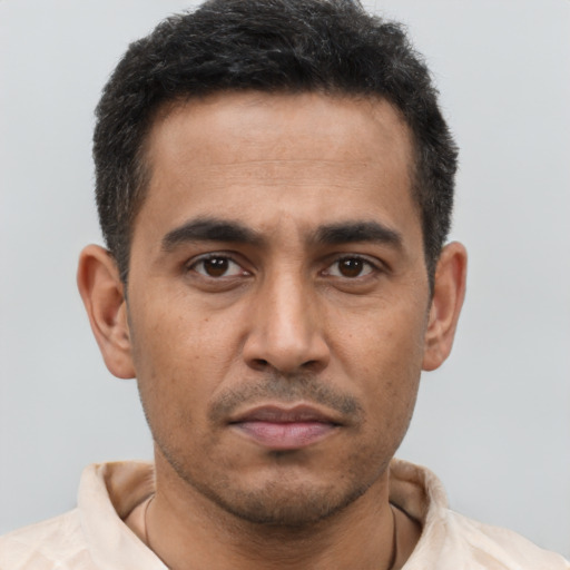 Neutral latino young-adult male with short  brown hair and brown eyes