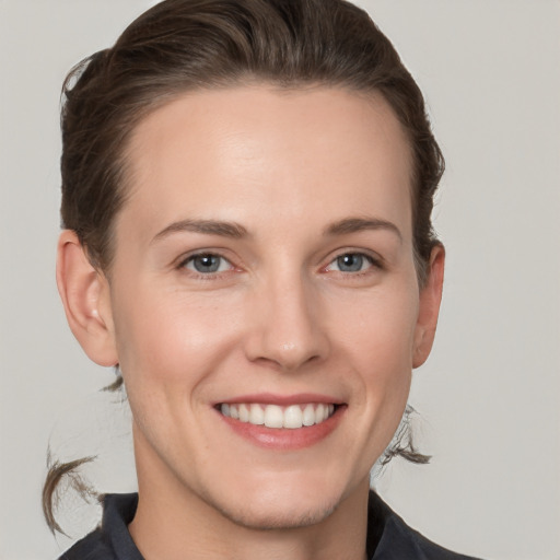 Joyful white young-adult female with short  brown hair and grey eyes