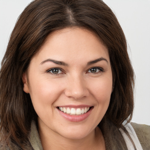 Joyful white young-adult female with medium  brown hair and brown eyes