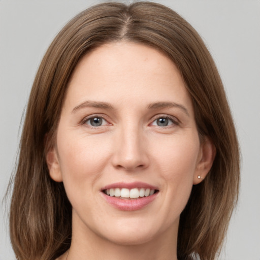 Joyful white young-adult female with medium  brown hair and grey eyes