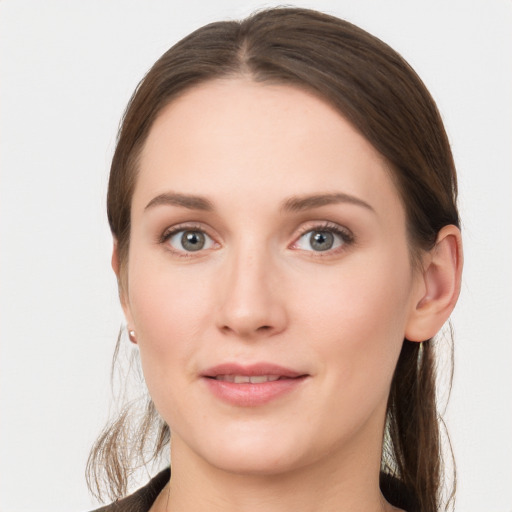 Joyful white young-adult female with long  brown hair and grey eyes