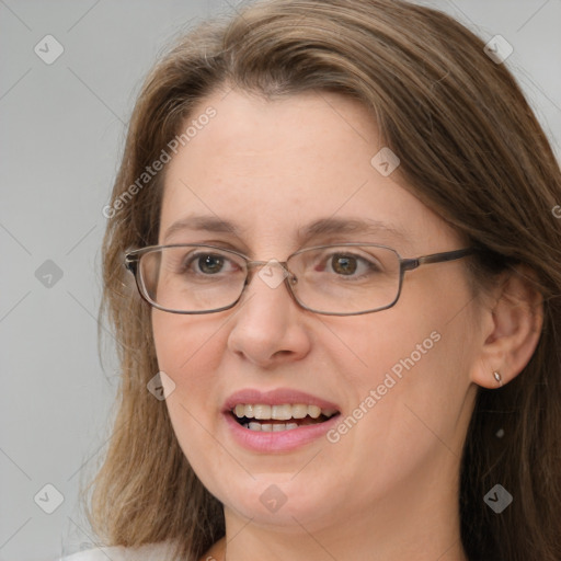 Joyful white adult female with long  brown hair and grey eyes