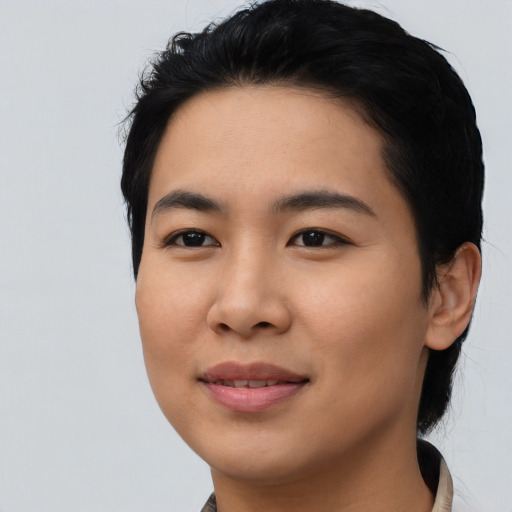 Joyful asian young-adult female with short  black hair and brown eyes