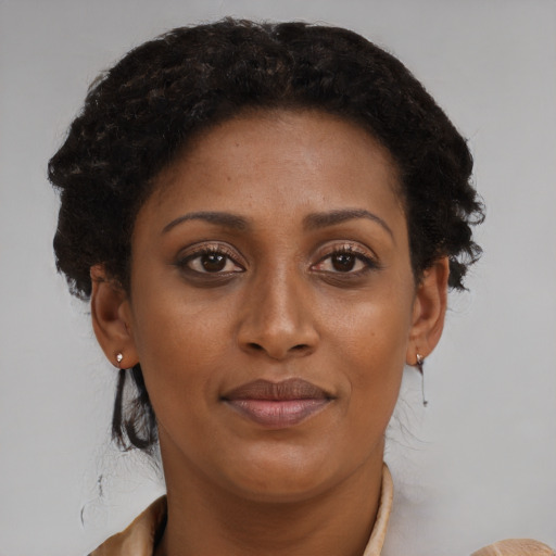 Joyful black adult female with medium  brown hair and brown eyes