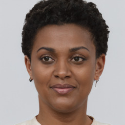 Joyful black young-adult female with short  brown hair and brown eyes