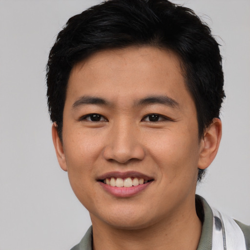 Joyful asian young-adult male with short  black hair and brown eyes