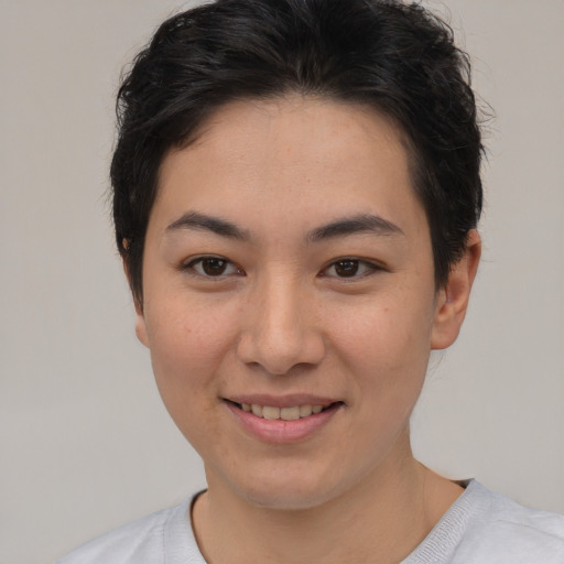 Joyful asian young-adult female with short  brown hair and brown eyes