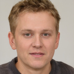 Joyful white young-adult male with short  brown hair and grey eyes