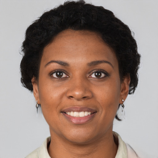 Joyful black young-adult female with short  brown hair and brown eyes
