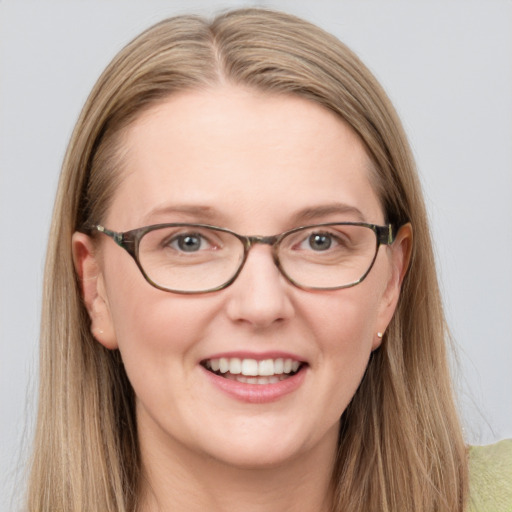 Joyful white adult female with long  brown hair and blue eyes