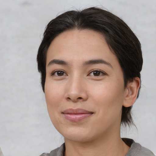 Joyful white young-adult female with medium  brown hair and brown eyes