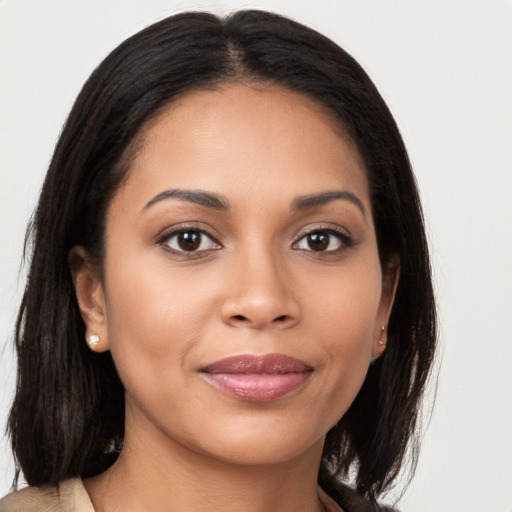 Joyful latino young-adult female with medium  brown hair and brown eyes