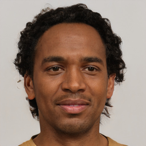 Joyful black adult male with short  brown hair and brown eyes