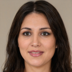 Joyful white adult female with long  brown hair and brown eyes