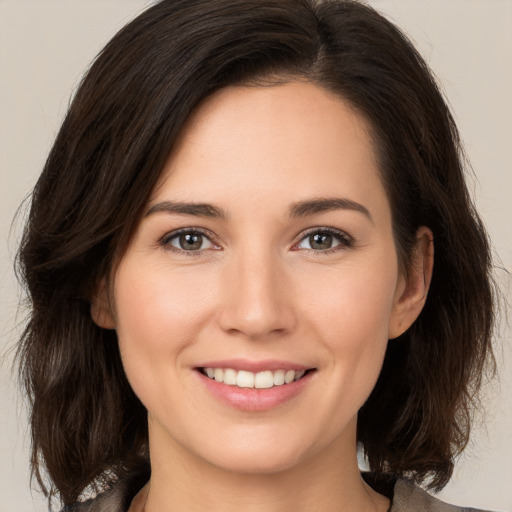 Joyful white young-adult female with medium  brown hair and brown eyes