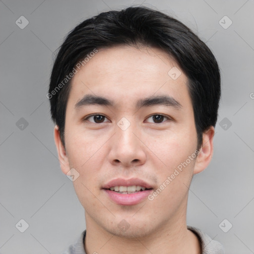 Joyful asian young-adult male with short  black hair and brown eyes