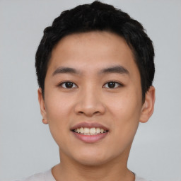 Joyful asian young-adult male with short  black hair and brown eyes