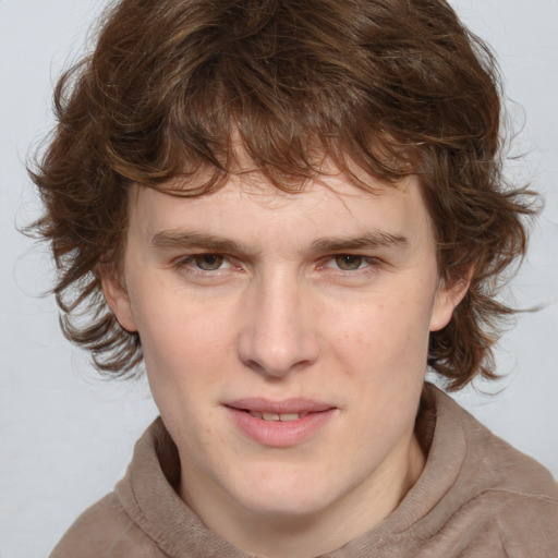 Joyful white young-adult male with medium  brown hair and brown eyes