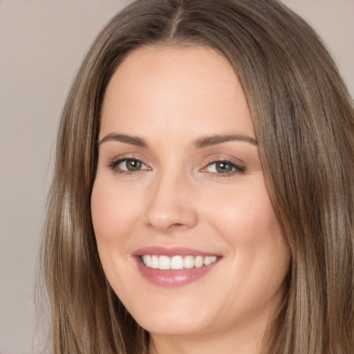 Joyful white young-adult female with long  brown hair and brown eyes