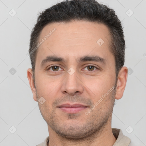 Joyful white young-adult male with short  brown hair and brown eyes