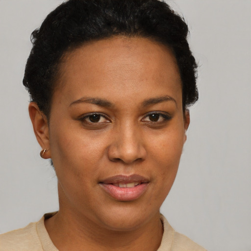 Joyful black young-adult female with short  brown hair and brown eyes