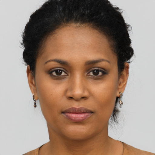 Joyful black young-adult female with short  black hair and brown eyes