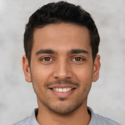 Joyful latino young-adult male with short  brown hair and brown eyes