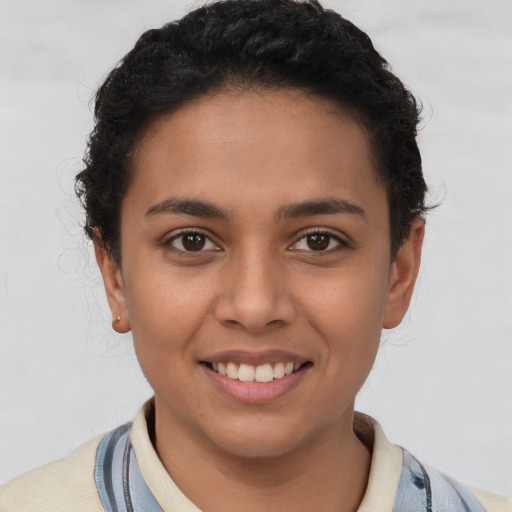 Joyful latino young-adult female with short  brown hair and brown eyes