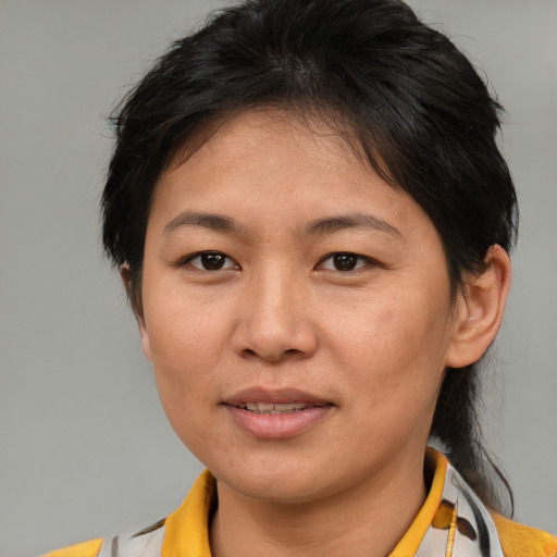Joyful asian adult female with medium  brown hair and brown eyes