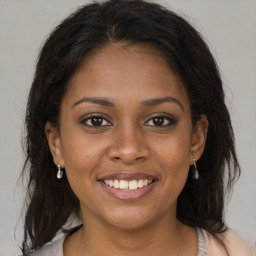 Joyful black young-adult female with medium  brown hair and brown eyes