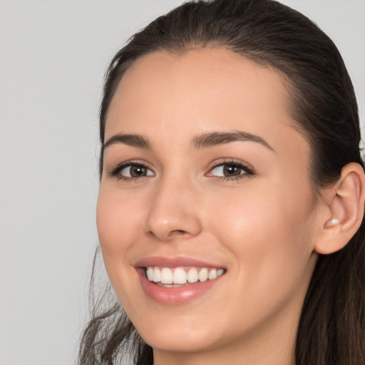 Joyful white young-adult female with long  brown hair and brown eyes