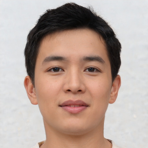 Joyful asian young-adult male with short  brown hair and brown eyes