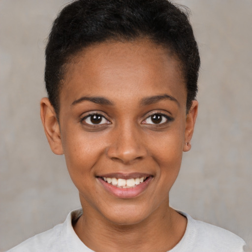 Joyful black young-adult female with short  brown hair and brown eyes