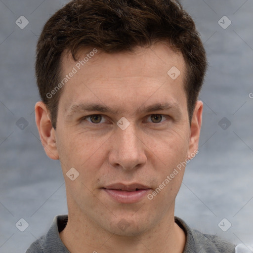 Joyful white adult male with short  brown hair and grey eyes