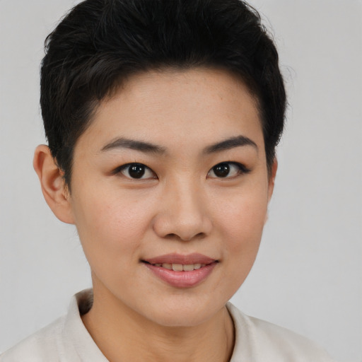 Joyful asian young-adult female with short  brown hair and brown eyes