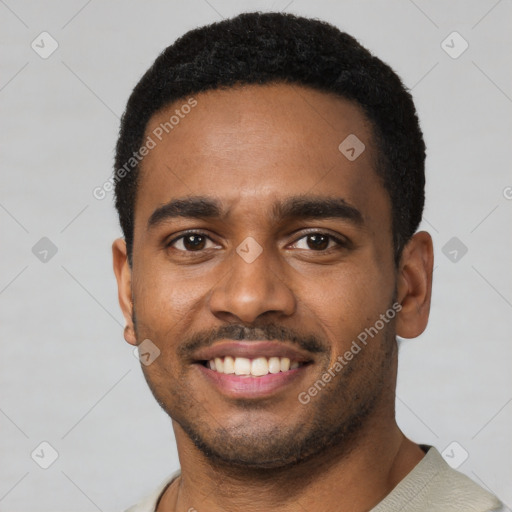 Joyful black young-adult male with short  black hair and brown eyes