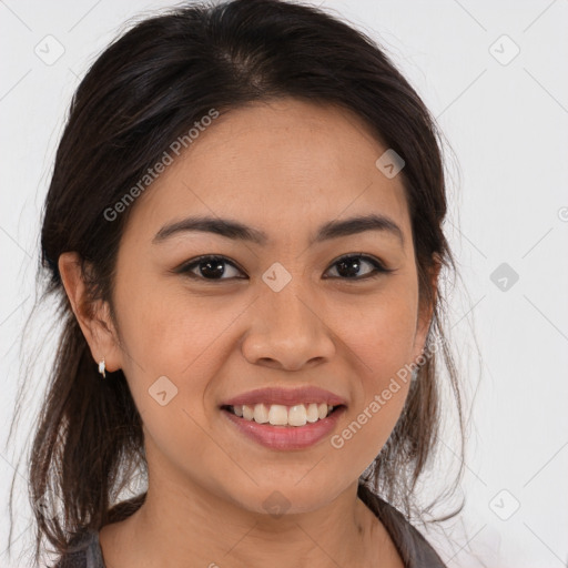 Joyful latino young-adult female with medium  brown hair and brown eyes