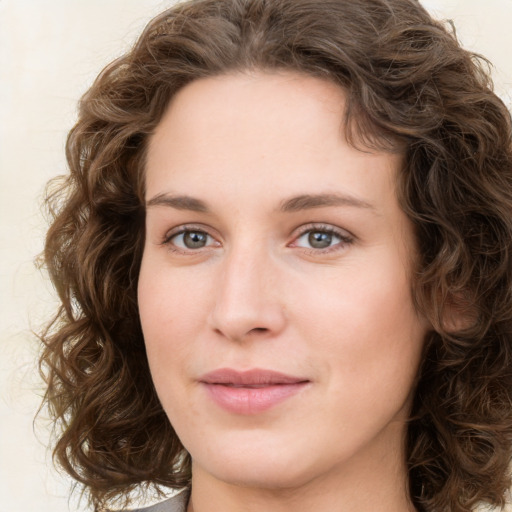 Joyful white young-adult female with medium  brown hair and green eyes