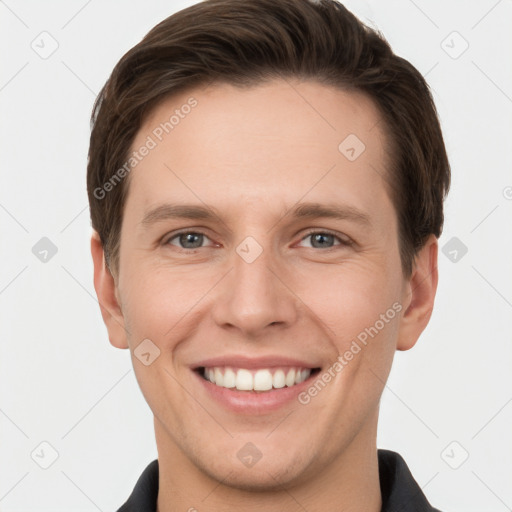 Joyful white young-adult male with short  brown hair and grey eyes