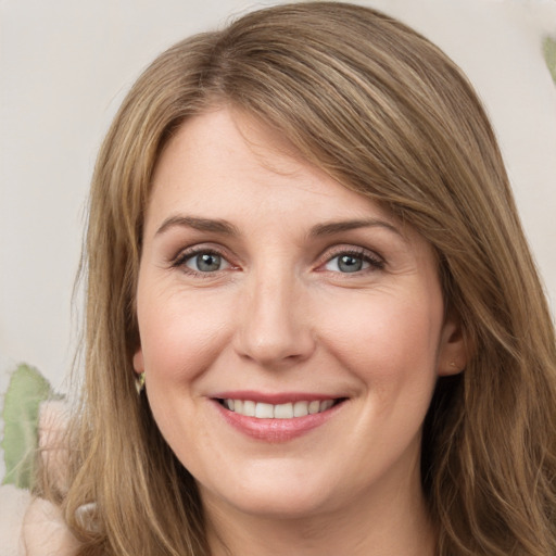 Joyful white young-adult female with long  brown hair and green eyes