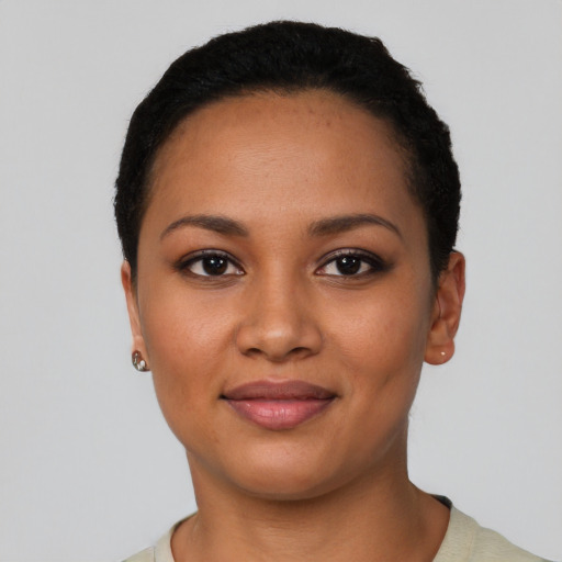 Joyful latino young-adult female with short  black hair and brown eyes