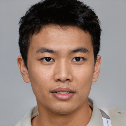 Joyful asian young-adult male with short  brown hair and brown eyes