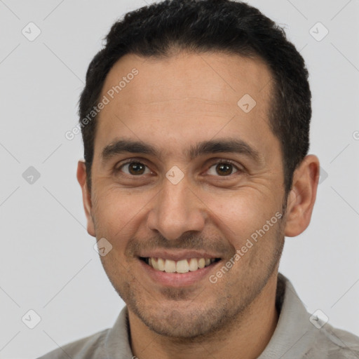 Joyful white young-adult male with short  black hair and brown eyes