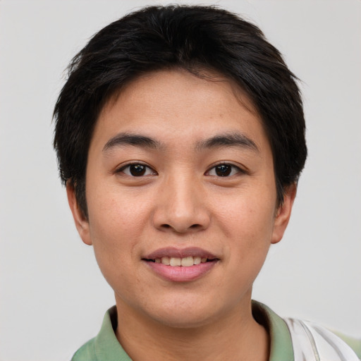 Joyful asian young-adult male with short  brown hair and brown eyes