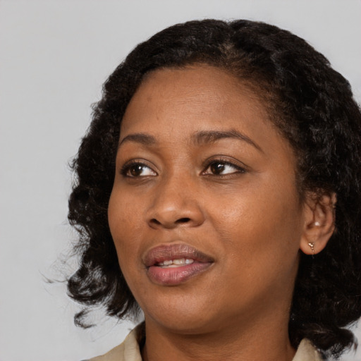 Joyful black adult female with medium  black hair and brown eyes