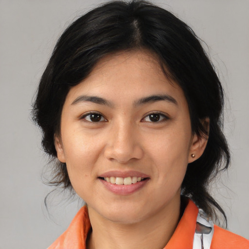 Joyful asian young-adult female with medium  black hair and brown eyes