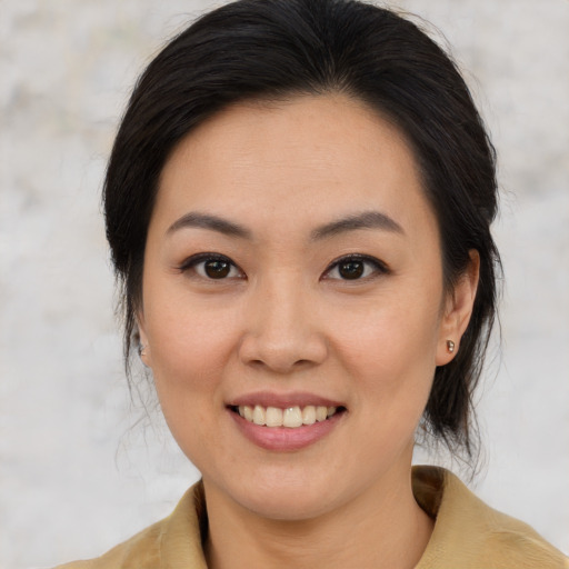 Joyful asian young-adult female with medium  brown hair and brown eyes