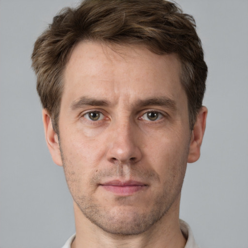 Joyful white adult male with short  brown hair and grey eyes